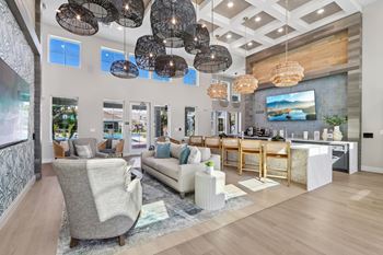 Clubhouse lounge with statement lighting and bar seating